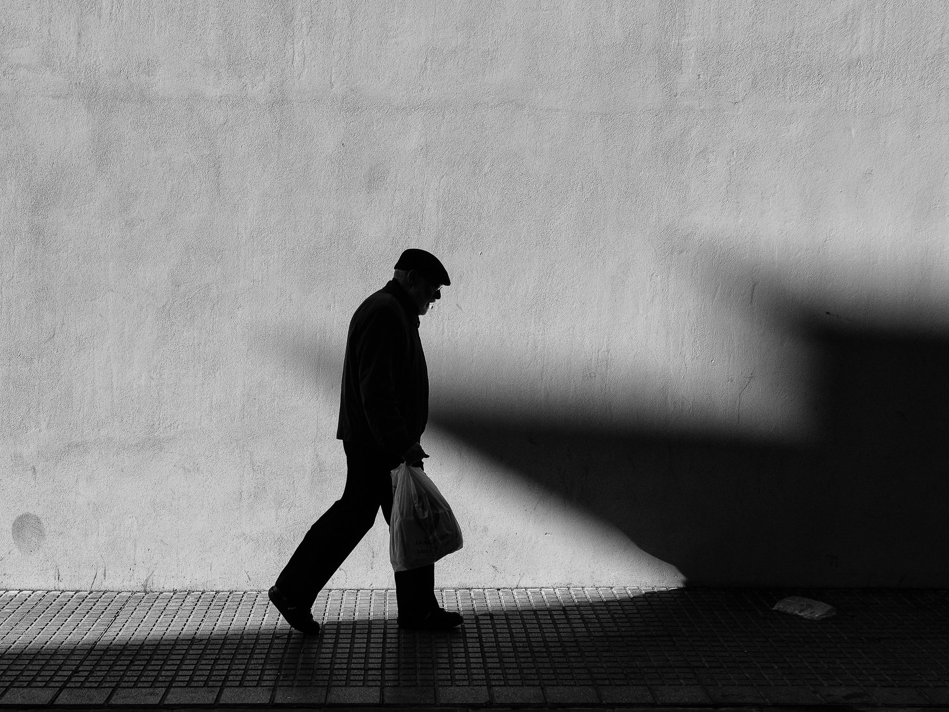 A solitary figure framed by the geometry of a city street